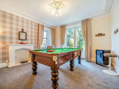 a room with a pool table and a fireplace at Torland in Dalserf