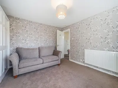 a living room with a couch and wallpaper at Torland in Dalserf