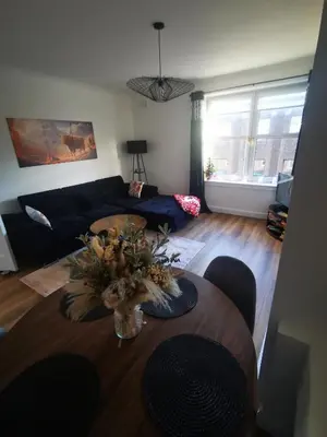 a living room with a table and a couch at Blanca apartment - free parking! in Oban