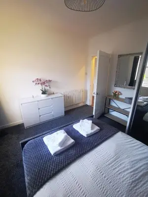 a bedroom with a bed with two towels on it at Blanca apartment - free parking! in Oban