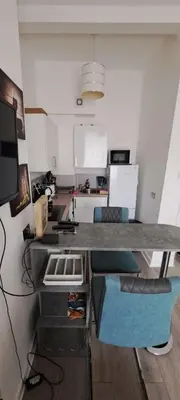 a kitchen with a counter top in a room at Cozy, modern flat in Govan in Glasgow