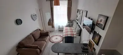a living room with a couch and a table at Cozy, modern flat in Govan in Glasgow
