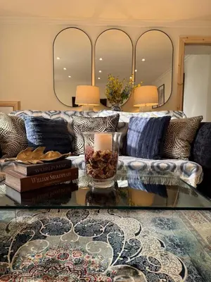 a living room with a couch and a glass table at Home away from home in Glasgow - Free Street Parking in Mansewood
