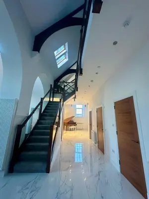 a staircase in a house with a stair case at The Bell Tower in Bonnybridge