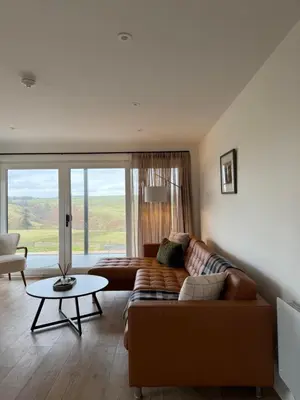 a living room with a couch and a table at West Riverside Farm in Stirling