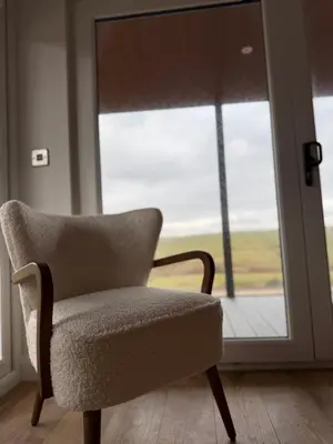 a chair sitting in front of a window at West Riverside Farm in Stirling
