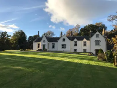 a large white house with a large yard at West Plean House in Stirling
