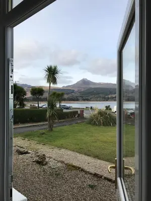 a view from a door looking out at the water at The Shorehouse in Brodick