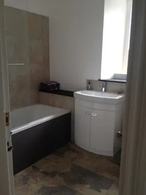 a bathroom with a tub and a sink and a bath tub at Creity Hall Guest House in Doune