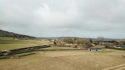 a park with a bench in the middle of a field at Threipmuir Lodge in Loanhead