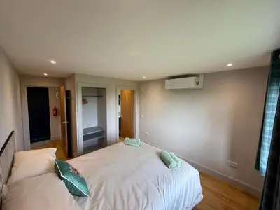 a bedroom with two beds in a room at Threipmuir Lodge in Loanhead