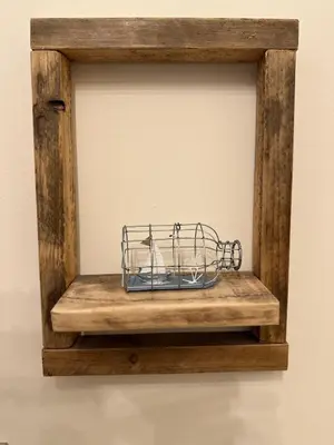 a metal wire basket on a wooden shelf on a wall at Sea Ayr - City Centre Apartment in Ayr