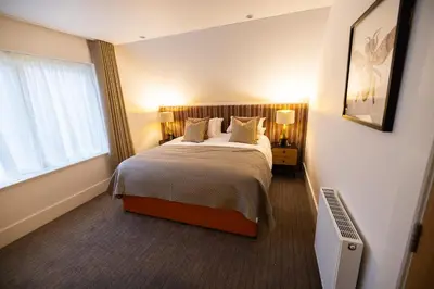 a bedroom with a bed and a window at Bracken Lodge in Comrie