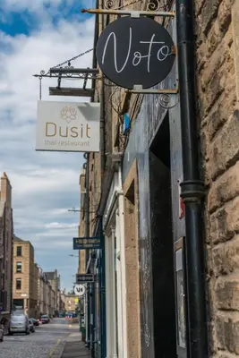 a sign on the side of a building on a street at The Cobbled Rider in Edinburgh