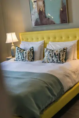 a bedroom with a large bed with pillows at The Cobbled Rider in Edinburgh