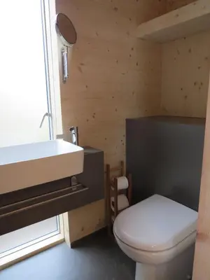 a bathroom with a white toilet and a sink at Cala Fearnadh Off-Grid cabin, Bunessan, Mull in Bunessan
