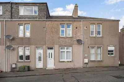 an old brick house with white doors and windows at Coaledge Coorie - A wee find in Fife in Fordell