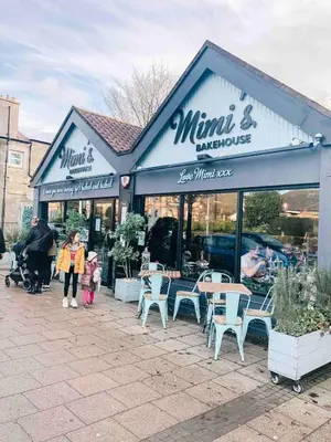 a store with tables and chairs outside of it at Chic flat close to Edinburgh, Airport, & Zoo in Edinburgh