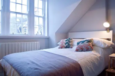 a bedroom with a bed with two pillows on it at The Muse in Edinburgh