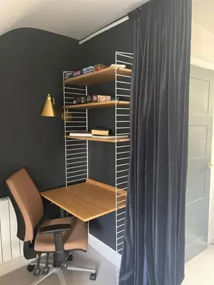 an office with a desk and a chair and shelves at The Muse in Edinburgh