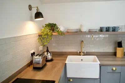 a kitchen with a sink and a counter with dishes at The Muse in Edinburgh