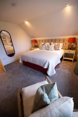 a hotel room with two beds and a mirror at Heather Lodge in Comrie