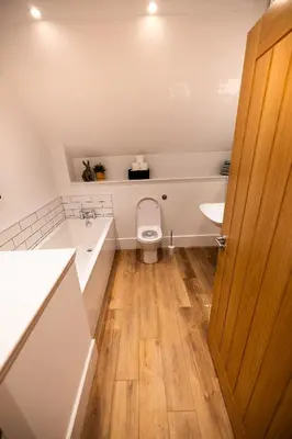 a bathroom with a toilet and a sink at Heather Lodge in Comrie