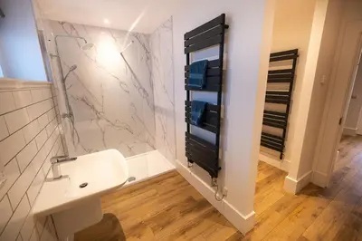 a bathroom with a sink and a shower at Heather Lodge in Comrie