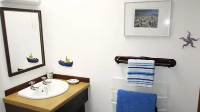 a bathroom with a sink and a mirror at Craobh Haven Cottages in Craobh Haven