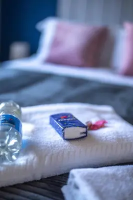 a bottle of water sitting on a towel on a bed at Camps Rigg Place in Livingston