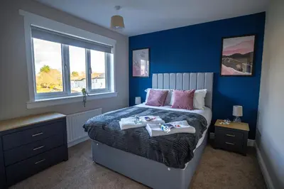 a bedroom with a bed with two towels on it at Camps Rigg Place in Livingston