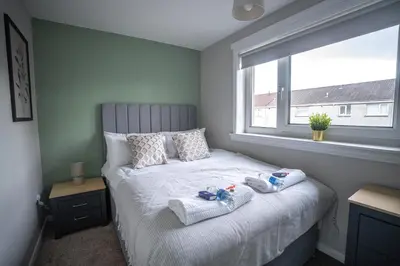 a bedroom with a bed with towels on it at Bank House in Livingston