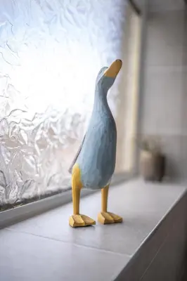 a plastic bird figurine sitting on a window sill at Muirhead House in Motherwell