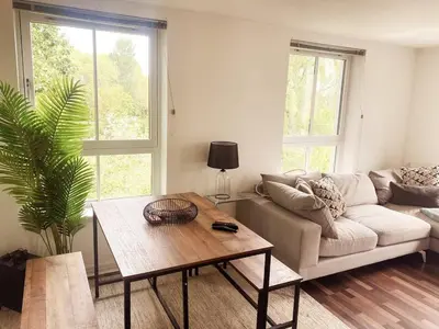 a living room with a couch and a table at Modern Two Bed Glasgow Apartment with Free Parking in Glasgow