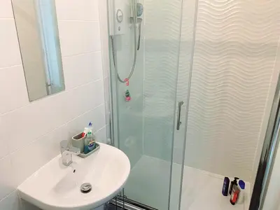 a bathroom with a shower and a sink at Modern Two Bed Glasgow Apartment with Free Parking in Glasgow