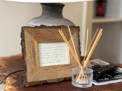 a picture in a wooden frame on a table with chopsticks at Bright Top Floor 2BR Apartment in Morningside, Easy City Centre Links, Close to University and Royal Hospital in Edinburgh
