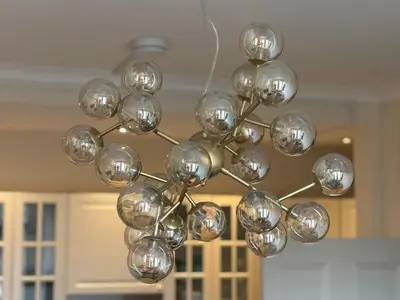 a chandelier hanging from a ceiling in a room at Bright Top Floor 2BR Apartment in Morningside, Easy City Centre Links, Close to University and Royal Hospital in Edinburgh