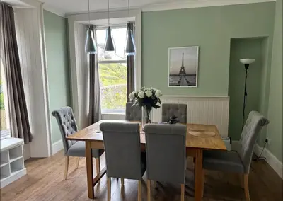 a dining room with a wooden table and chairs at Snug Loft Room, Room 5, Beautiful Connel near Oban in Connel