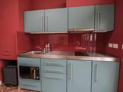 a kitchen with blue cabinets and a sink at Tirlaggan Studio in Oban