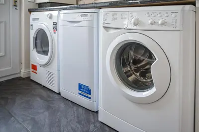 two white washing machines sitting next to each other at 3-Bed Home Near Town Center in Stirling