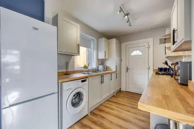 a kitchen with a washer and dryer at Charming Terrace House for Relaxing Retreat in Dumbarton