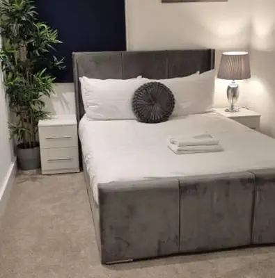 a bedroom with a large bed with a metal headboard at Apartment In Canary Wharf, London in Moffat
