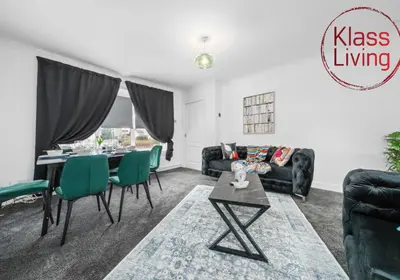 a living room with a table and green chairs at Orbiston House by Klass Living Bellshill in Bellshill