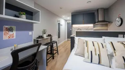 a living room with a bed and a kitchen at For Students Only Clyde Court Glasgow in Glasgow