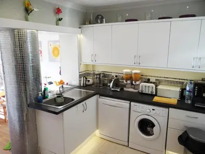 a kitchen with a sink and a washing machine at Rustic Harmony - Edinburgh Airport near, 8mi in Rosyth
