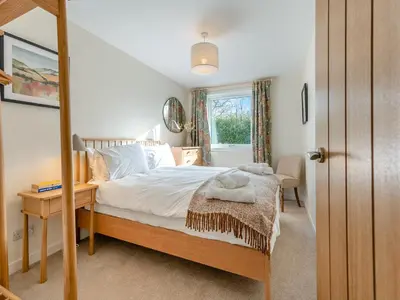 a bedroom with a bed and a window at Newbigging Farm Cottage in Auchterarder
