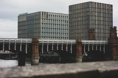 a bridge over a river with buildings in the background at Quiet City Centre, King & Sofa Bed in Glasgow