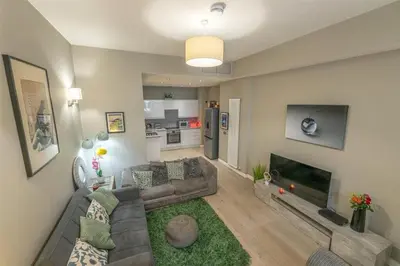 a living room with a couch and a fireplace at Modern Main Door Flat Edinburgh City Center in Edinburgh