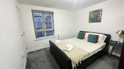 a bedroom with a bed and a window at Modern Main Door Flat Edinburgh City Center in Edinburgh