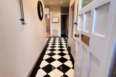 a hallway with a black and white checkered floor at Glasgow City - Large Stylish 2 Bed Flat in Unique Ibrox Location Walking Distance to Subway and Free On-Street Parking in Glasgow